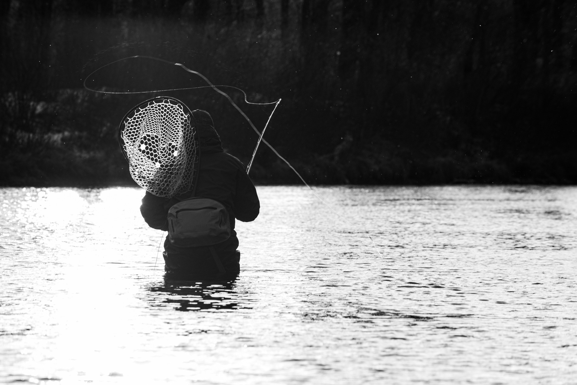 a fly fisherman casting on a cloudy day in New Hampshire
